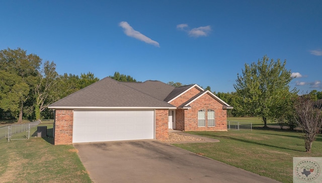 view of front of house featuring a garage and a front yard