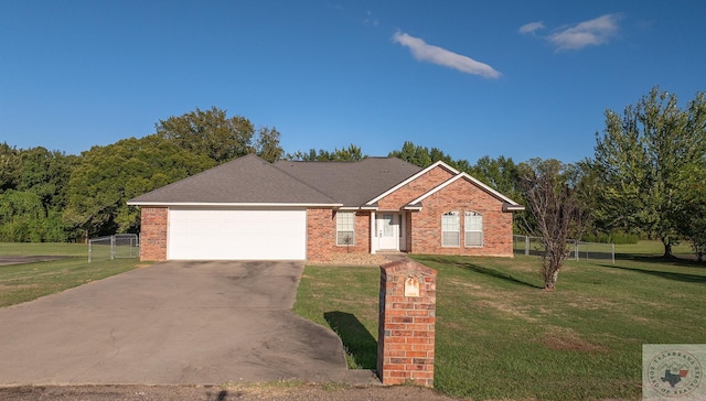 ranch-style home featuring a garage and a front yard