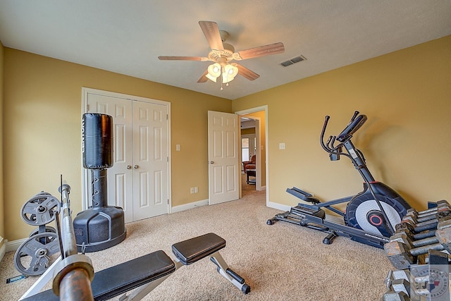 exercise room with carpet flooring and ceiling fan