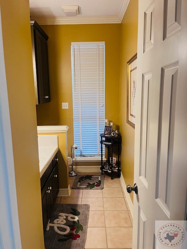 bathroom featuring tile patterned floors, vanity, and ornamental molding