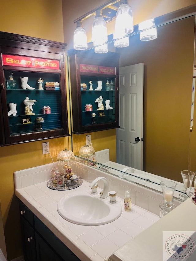 bathroom with vanity and an inviting chandelier