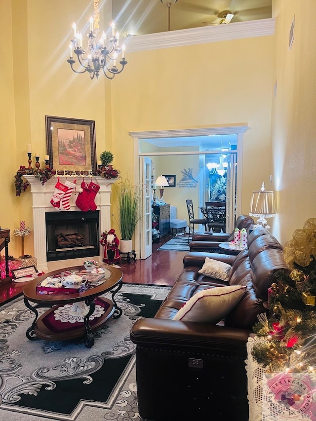 living room with a chandelier, crown molding, and wood-type flooring