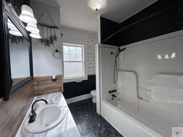 full bathroom featuring tub / shower combination, toilet, a textured ceiling, and vanity