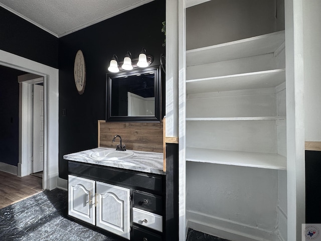 bathroom with a textured ceiling and vanity