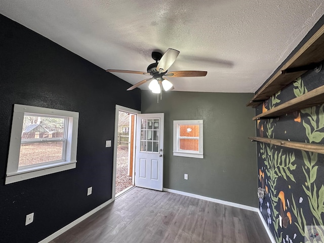 unfurnished room featuring hardwood / wood-style floors, a textured ceiling, and ceiling fan