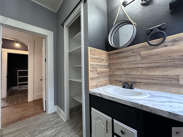 bathroom featuring vanity and ornamental molding