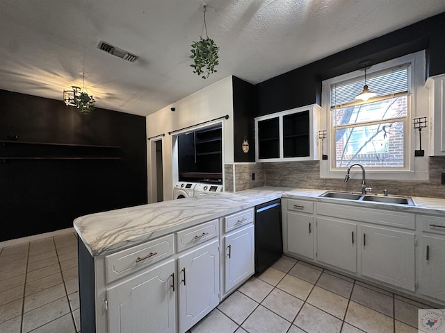 kitchen featuring decorative backsplash, sink, white cabinetry, and black dishwasher