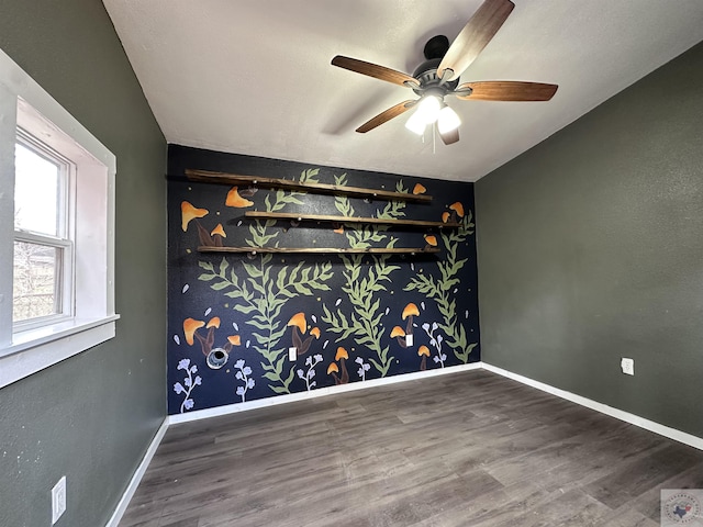 empty room featuring ceiling fan and dark hardwood / wood-style flooring