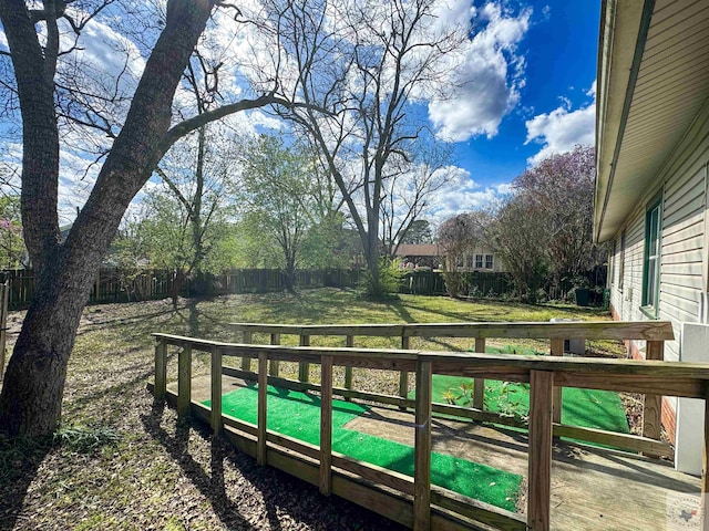 wooden terrace featuring a lawn