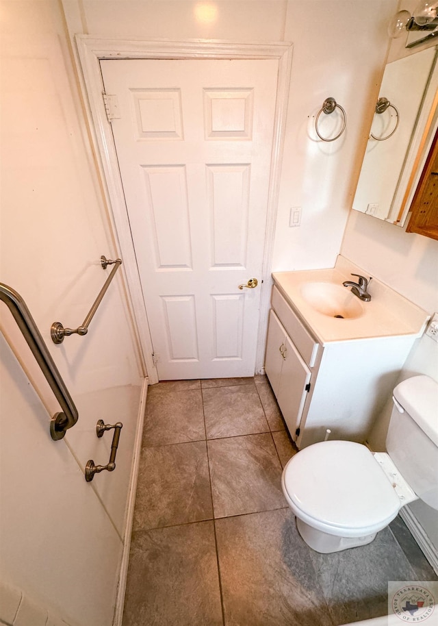 bathroom featuring vanity, toilet, and tile patterned floors