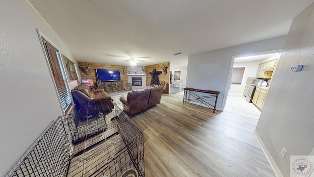 living room featuring a fireplace, light hardwood / wood-style flooring, and ornamental molding