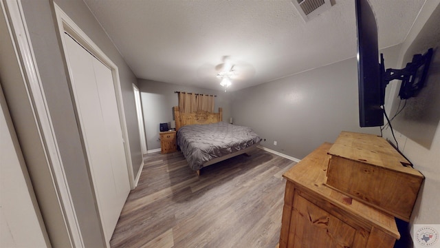 bedroom featuring a textured ceiling and light wood-type flooring