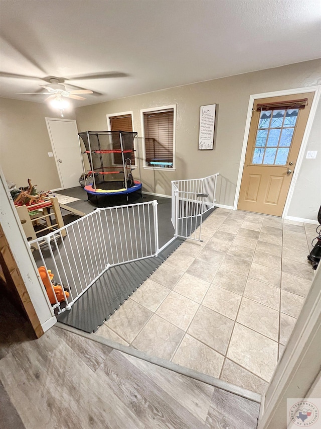 tiled foyer entrance featuring ceiling fan