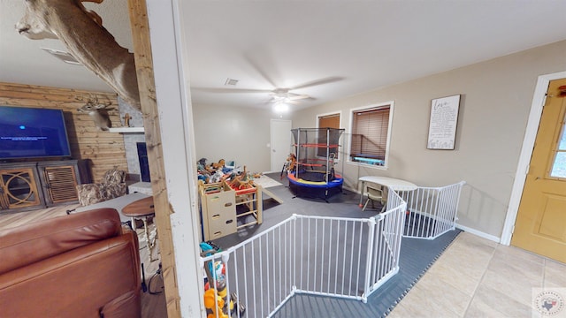 recreation room featuring light tile patterned floors and ceiling fan