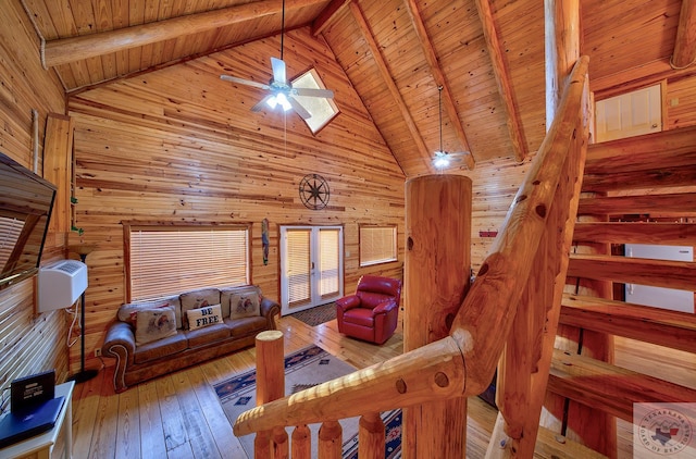 living room featuring wooden ceiling, hardwood / wood-style floors, beam ceiling, and wooden walls