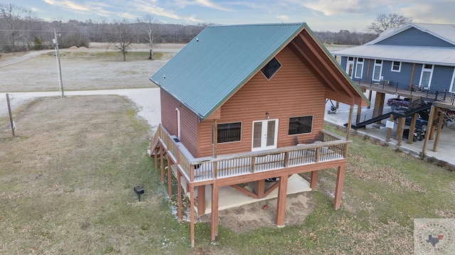 back of house featuring a deck and french doors