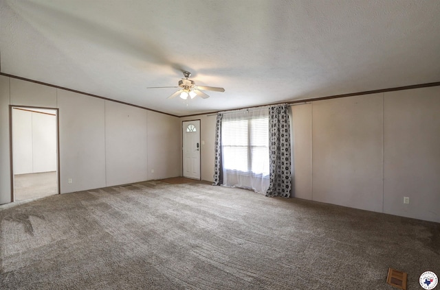 9960 W New Boston Rd, Hooks, TX 75561 - carpeted spare room featuring visible vents, ceiling fan, ornamental molding, and a textured ceiling