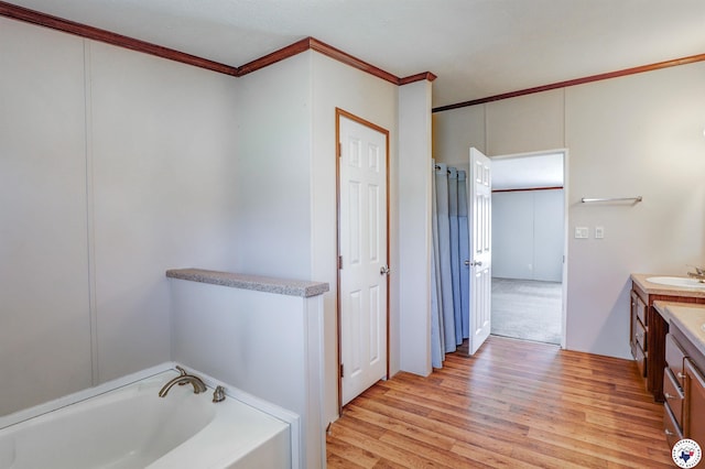 9960 W New Boston Rd, Hooks, TX 75561 - bathroom with ornamental molding, wood finished floors, a garden tub, and vanity