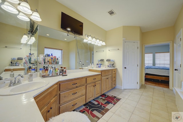 full bath featuring visible vents, a sink, connected bathroom, tile patterned flooring, and double vanity