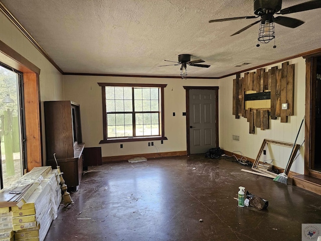 misc room featuring plenty of natural light, a textured ceiling, and crown molding