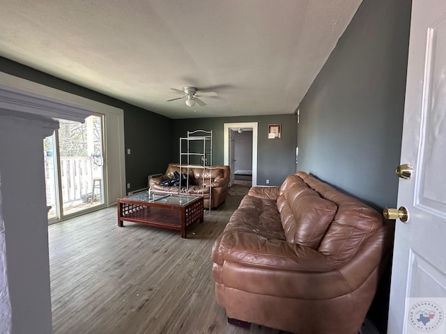 living room with wood-type flooring and ceiling fan