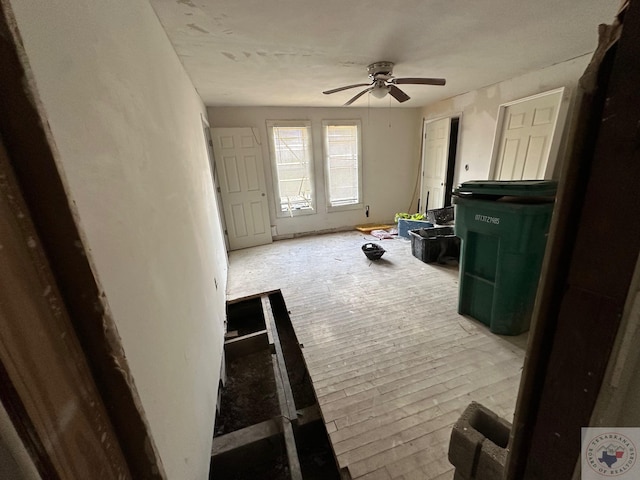 interior space with ceiling fan