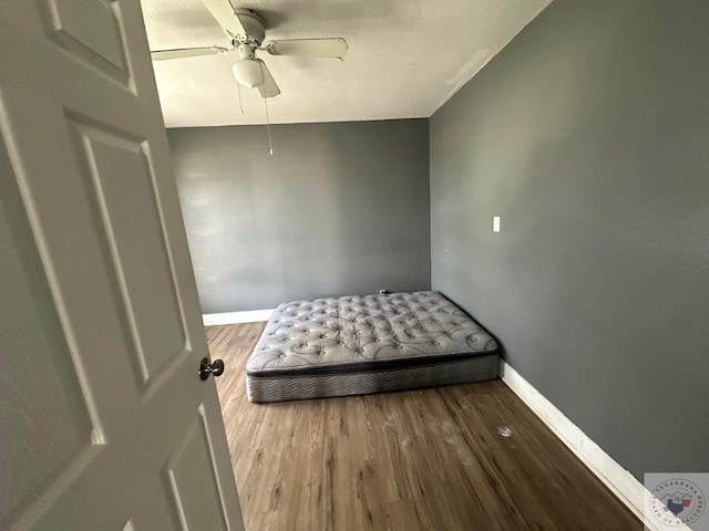 bedroom with wood-type flooring and ceiling fan