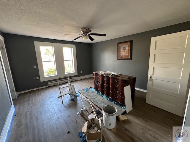 miscellaneous room featuring ceiling fan, hardwood / wood-style floors, a textured ceiling, and a baseboard heating unit