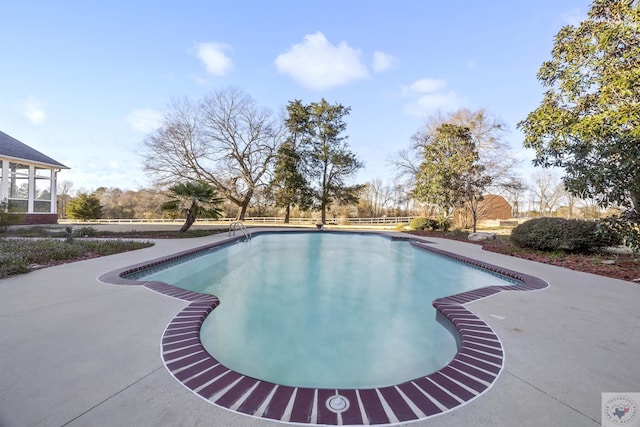 view of swimming pool featuring a fenced in pool and fence