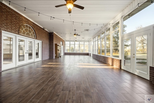 unfurnished sunroom featuring french doors, plenty of natural light, and rail lighting