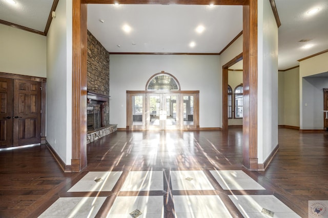 interior space featuring a stone fireplace, baseboards, and wood finished floors