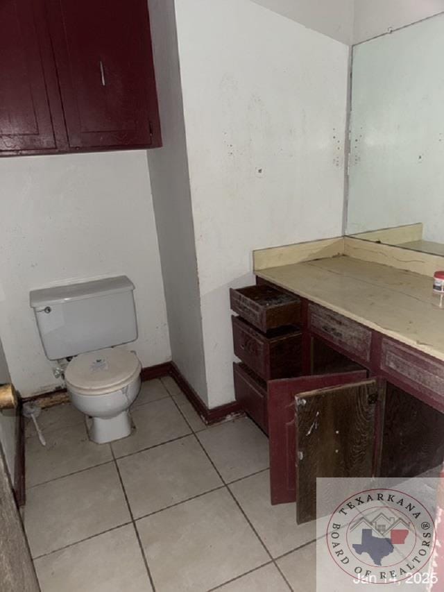 bathroom with toilet and tile patterned floors