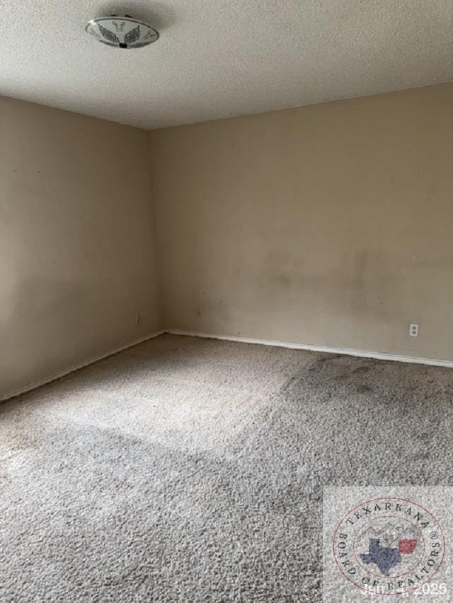 empty room featuring a textured ceiling