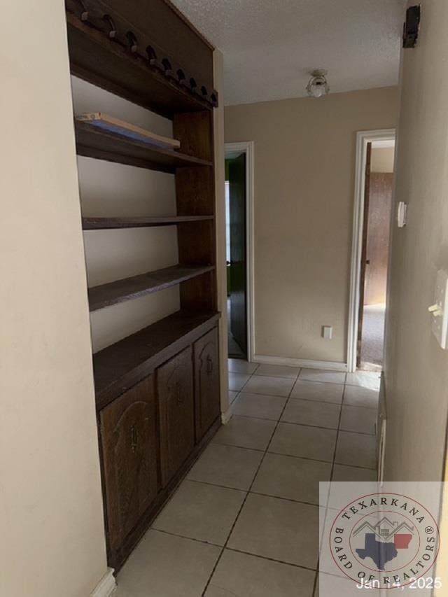 hall with light tile patterned flooring