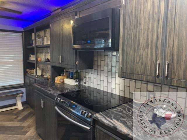 kitchen with dark brown cabinets, dark stone counters, dark parquet flooring, electric stove, and decorative backsplash