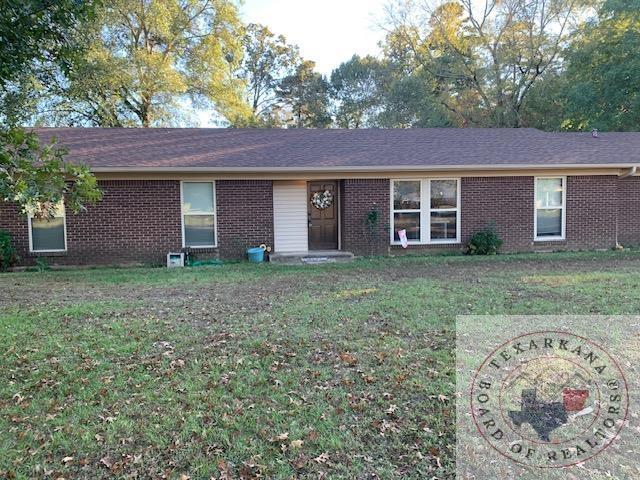 ranch-style home with a front lawn