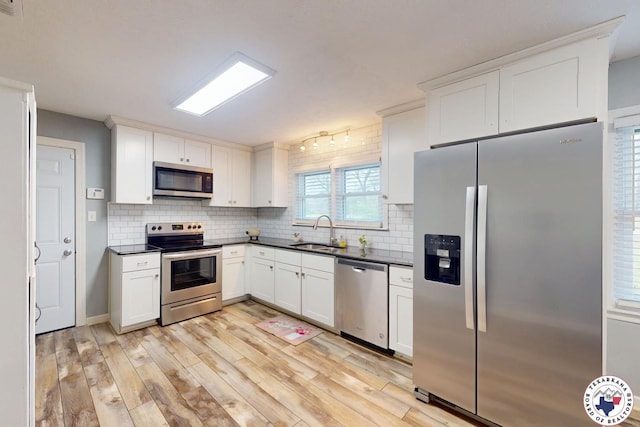 2101 N Fm 2148, Texarkana, TX 75501 - kitchen with appliances with stainless steel finishes, a sink, dark countertops, and decorative backsplash
