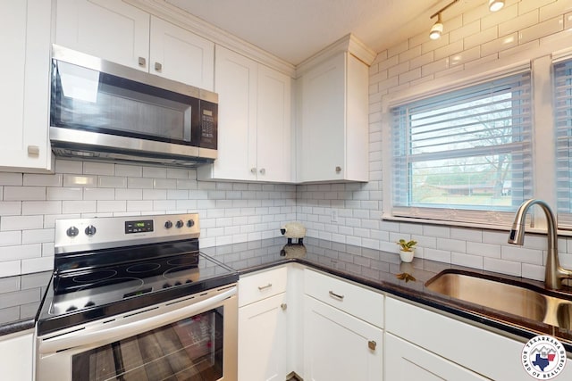 2101 N Fm 2148, Texarkana, TX 75501 - kitchen with stainless steel appliances, a sink, white cabinetry, and decorative backsplash