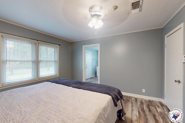 2101 N Fm 2148, Texarkana, TX 75501 - bedroom with wood finished floors, ornamental molding, baseboards, and ceiling fan