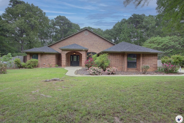 25 Dunham Dr, Texarkana, TX 75503 - single story home featuring brick siding, fence, a front yard, and roof with shingles