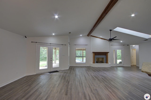 25 Dunham Dr, Texarkana, TX 75503 - unfurnished living room with wood finished floors, lofted ceiling with beams, a fireplace, baseboards, and a ceiling fan