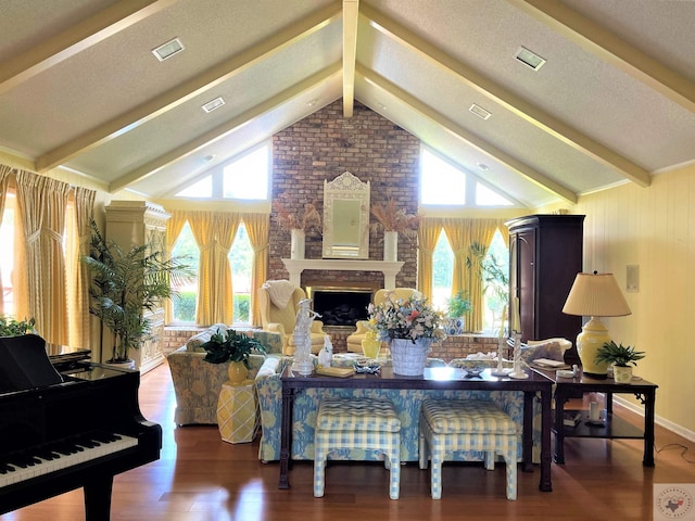 501 Park St, Atlanta, TX 75551 - living room with a brick fireplace, a textured ceiling, beamed ceiling, and wood finished floors