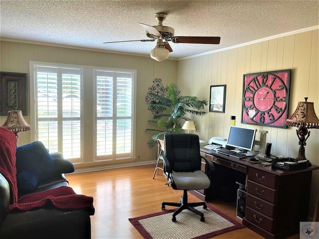 501 Park St, Atlanta, TX 75551 - home office featuring a textured ceiling, ceiling fan, ornamental molding, and wood finished floors