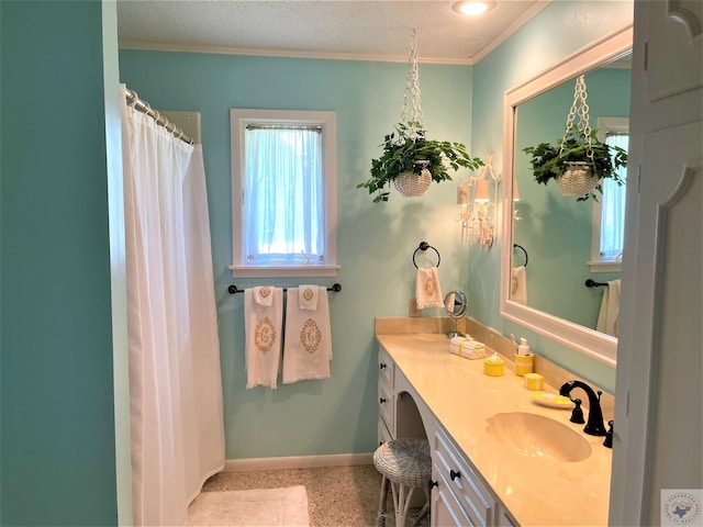 501 Park St, Atlanta, TX 75551 - full bath with ornamental molding, a textured ceiling, vanity, baseboards, and speckled floor