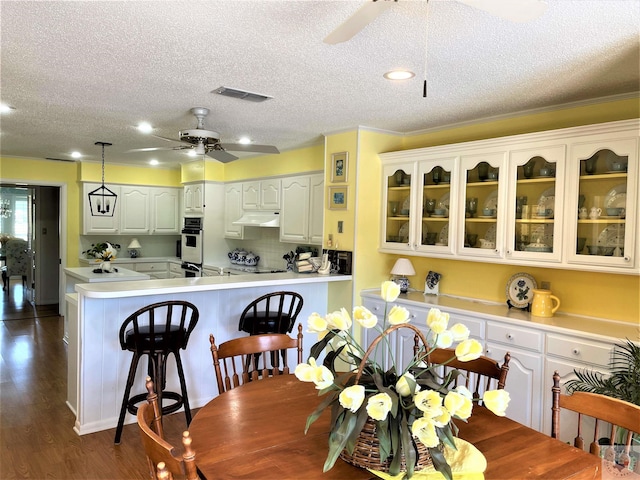 501 Park St, Atlanta, TX 75551 - dining room with dark wood-style floors, visible vents, ceiling fan, and a textured ceiling