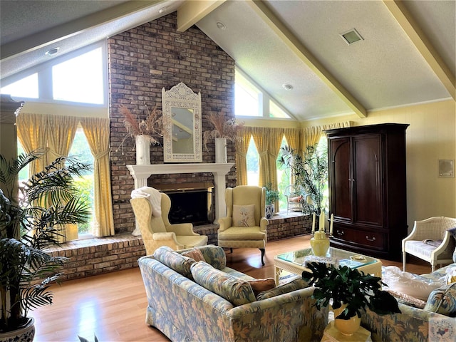 501 Park St, Atlanta, TX 75551 - sitting room featuring high vaulted ceiling, light wood-type flooring, a brick fireplace, and beam ceiling