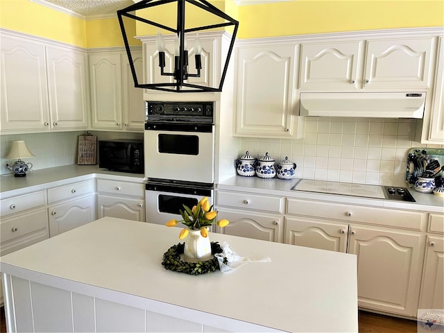 501 Park St, Atlanta, TX 75551 - kitchen with tasteful backsplash, white double oven, electric stovetop, under cabinet range hood, and black microwave