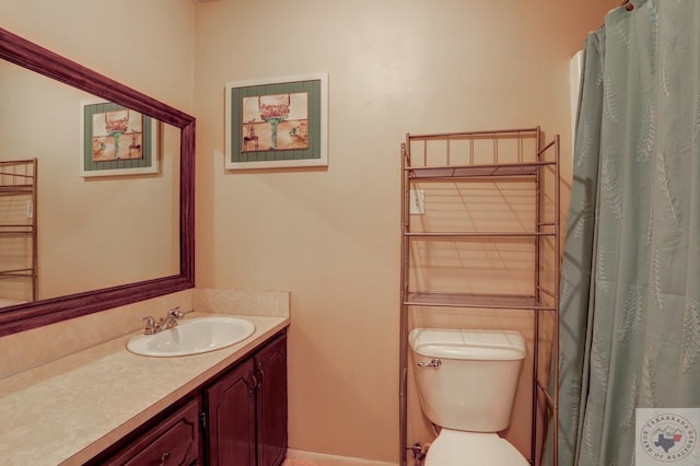 bathroom with toilet and vanity