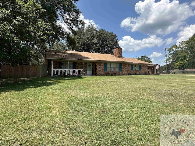 single story home featuring covered porch and a front lawn