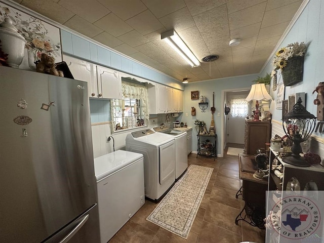 laundry area with separate washer and dryer and ornamental molding